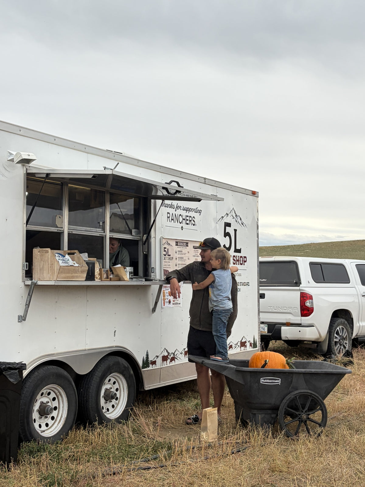 Family beside the 5L burger trailer window