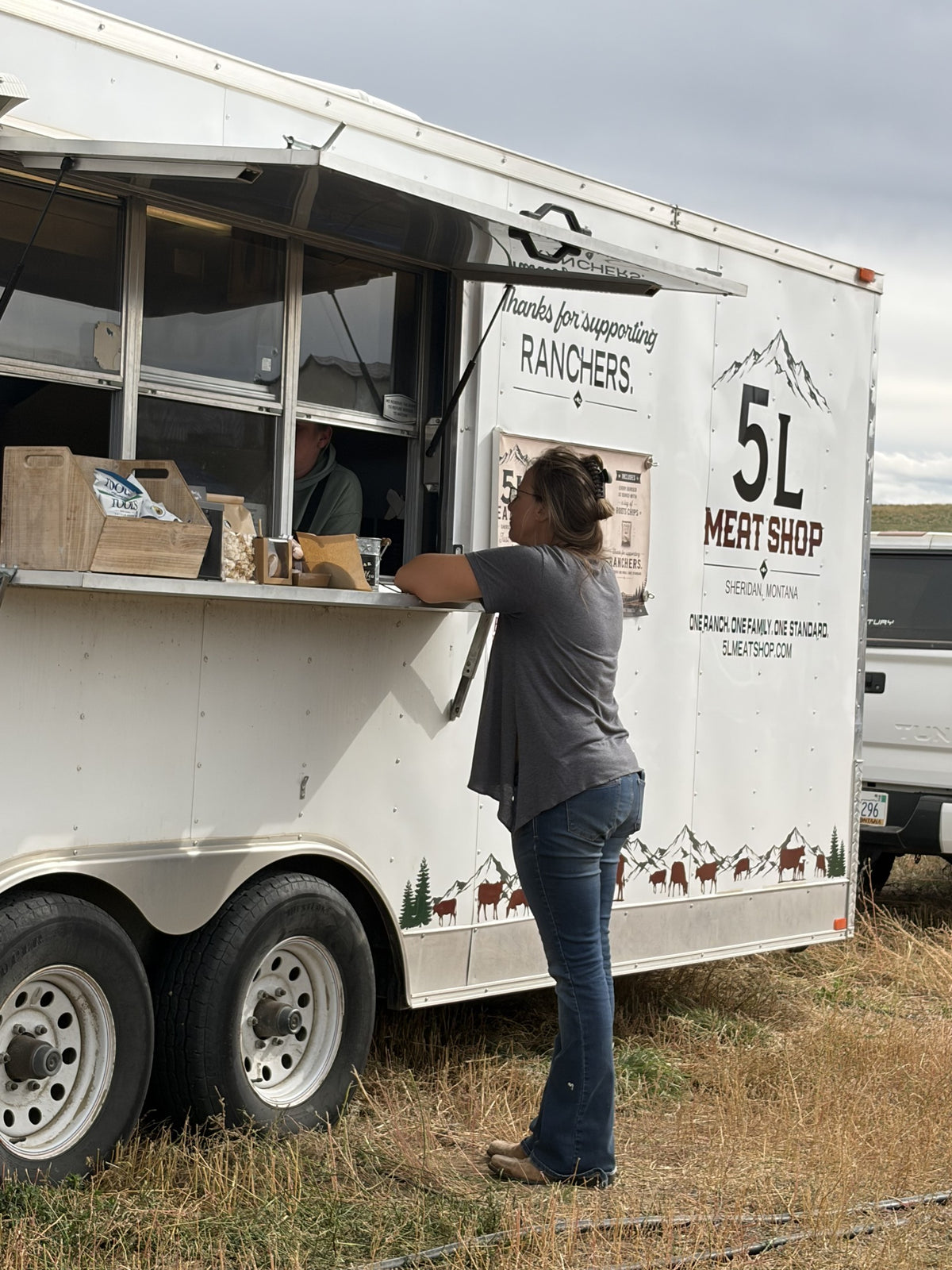 A customer visiting the 5L trailer serving window
